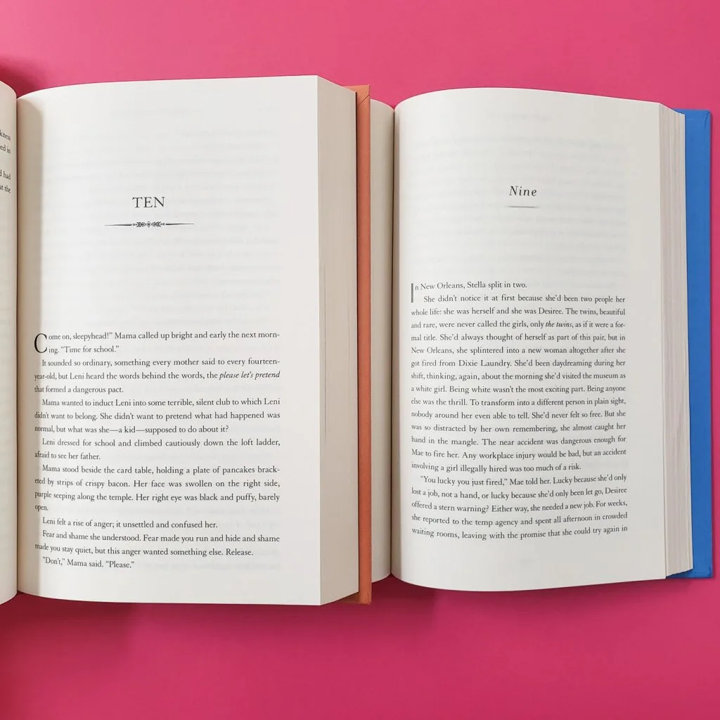 Two open books on pink background
