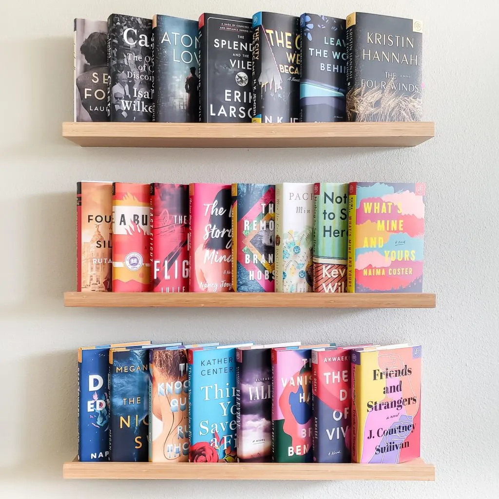3 rows of books on ledge shelving