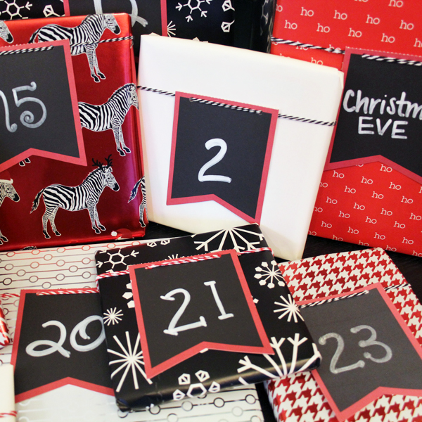 Books wrapped in red white and black wrapping paper with numbered gift tags