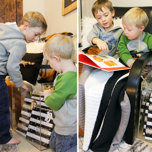 two little boys reading Christmas book together under a blanket