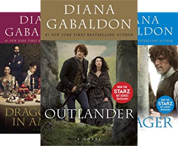 Three books in outlander series with outlander on top