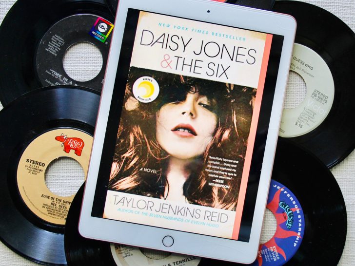 Cover of Daisy Jones and The Six box on an iPad laying on top of six vinyl records.