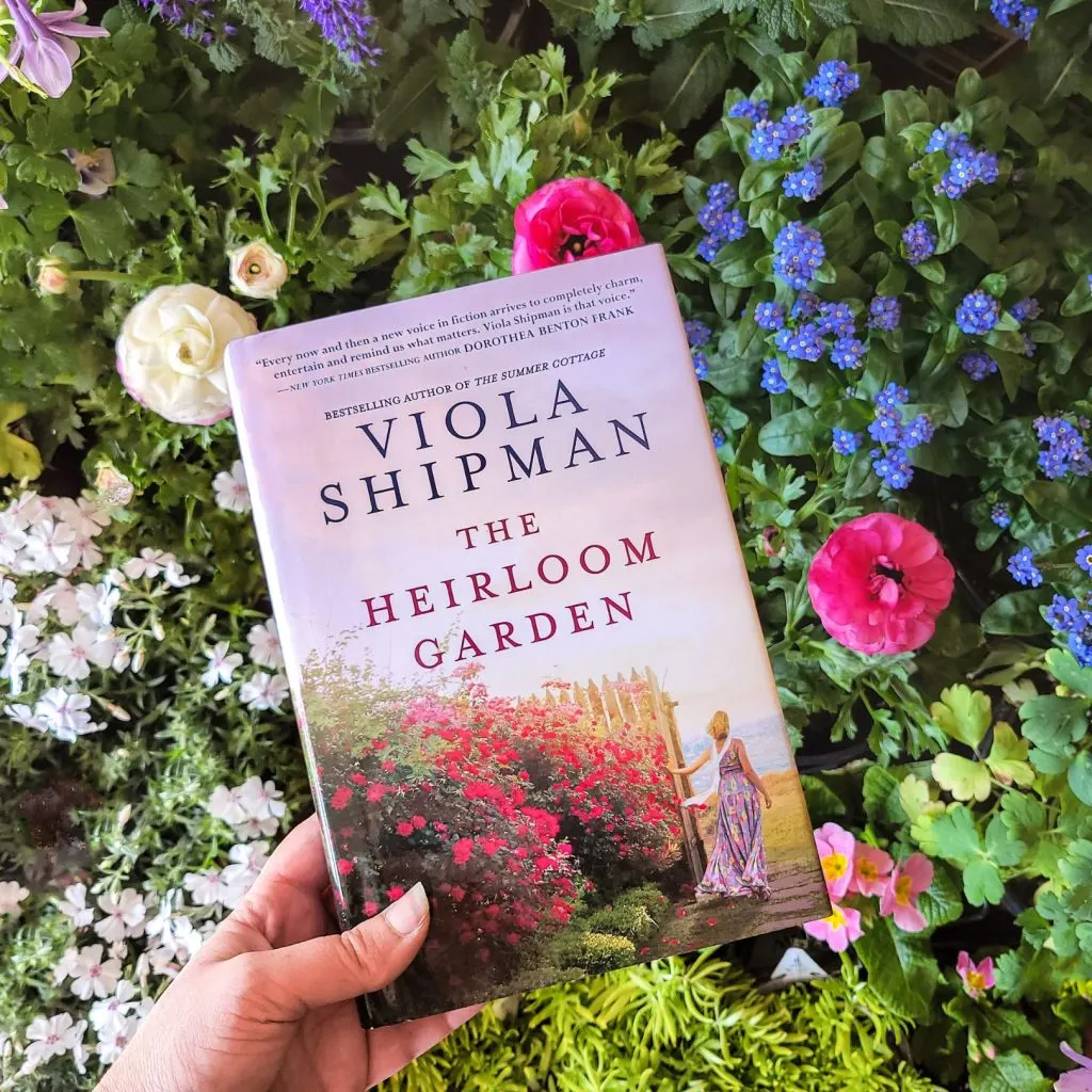 The Heirloom Garden book with woman next to a wall of flowers on the cover
