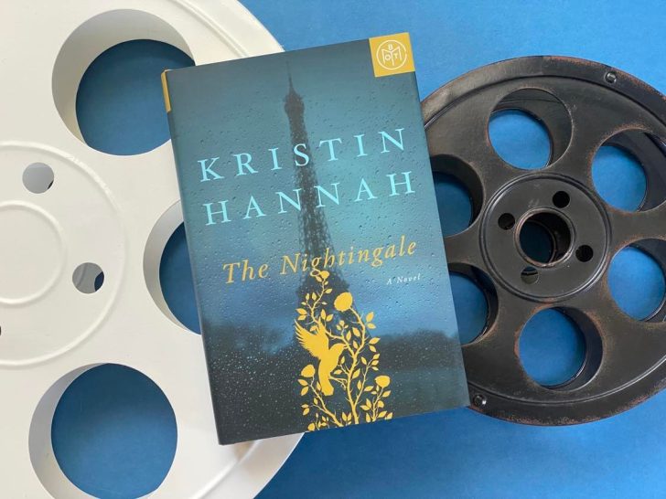 Photo of the Kristin Hannah book, The Nightingale, sitting atop two film reels.