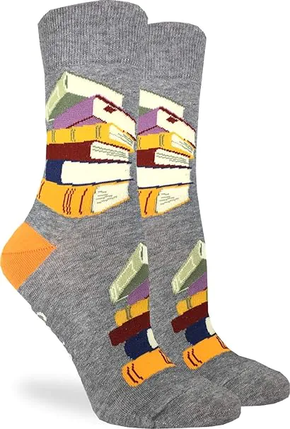 Gray socks with gold heals and stacks of books in shades of gold, green and blue