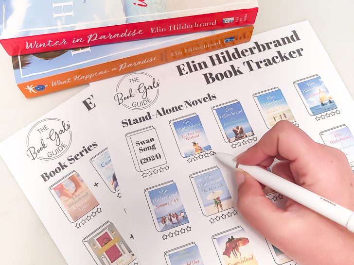 Photo of the two page printable Elin Hilderbrand Book List featuring each book cover and stars to fill in ratings. A hand is holding a pen about to fill in the stars, and two Elin Hilderbrand books are stacked up at the top of the photo.