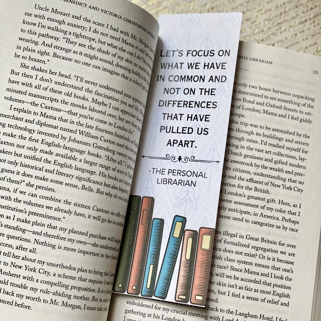 An open copy of The Personal Librarian with a custom bookmark between the pages from the printable book club guide.