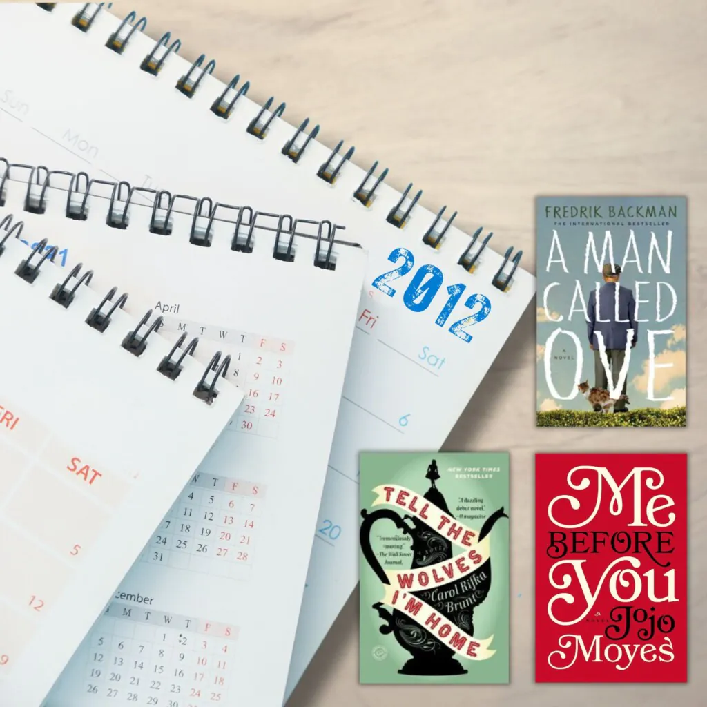 Stack of 2012 calendars on a wood desk with three book covers