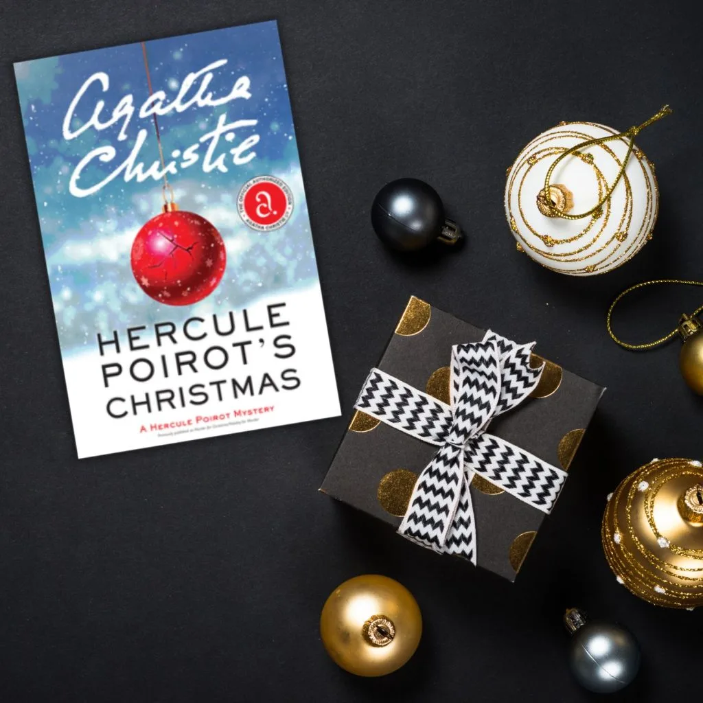 Hercule Poirot's Christmas book cover in a black and gold christmas scene