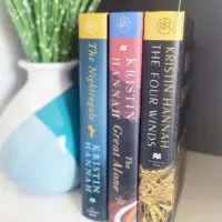 3 Kristin Hannah book spines: The Nightingale, The Great Alone, and The Four Winds