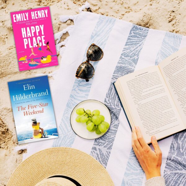 overhead view of woman reading on a beach blanket