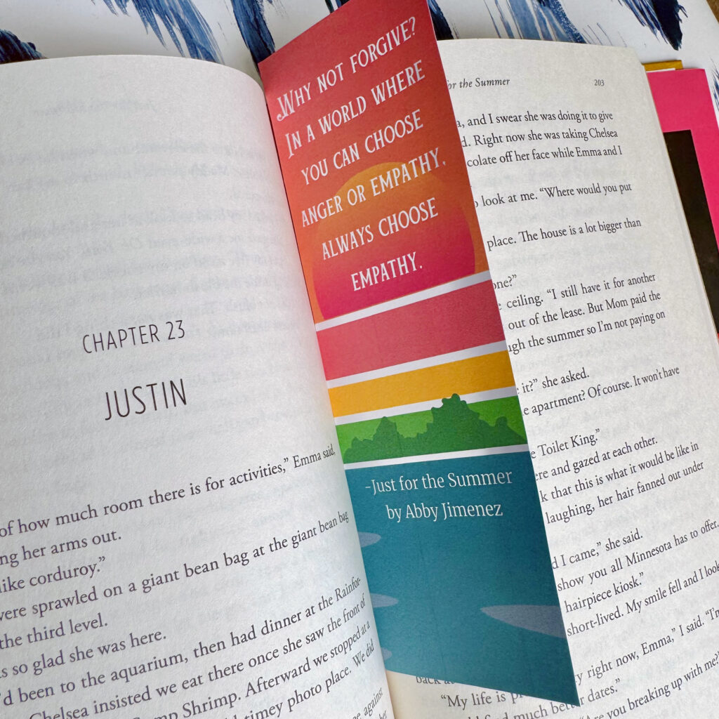 Custom printable bookmark between the open pages of Just for the Summer by Abby Jimenez with a quote from the book that reads "Why not forgive? In a world where you can choose anger or empathy, always choose empathy."