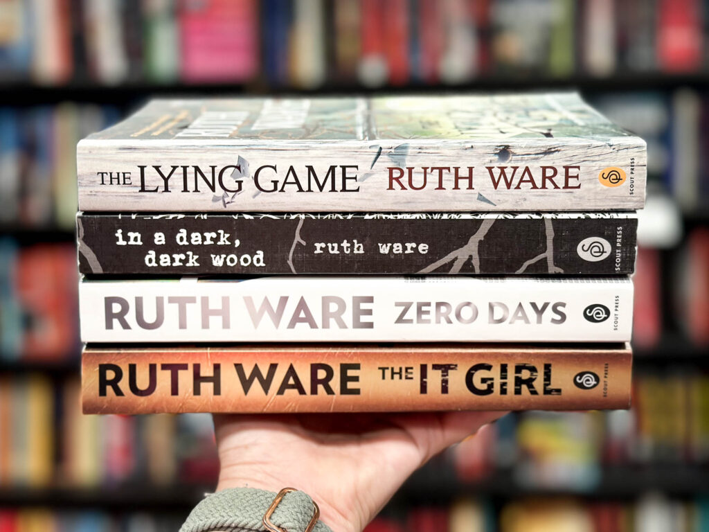 stack of 4 Ruth Ware books on a hand