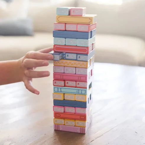 Wooden block stacking game with pieces that look like book spines
