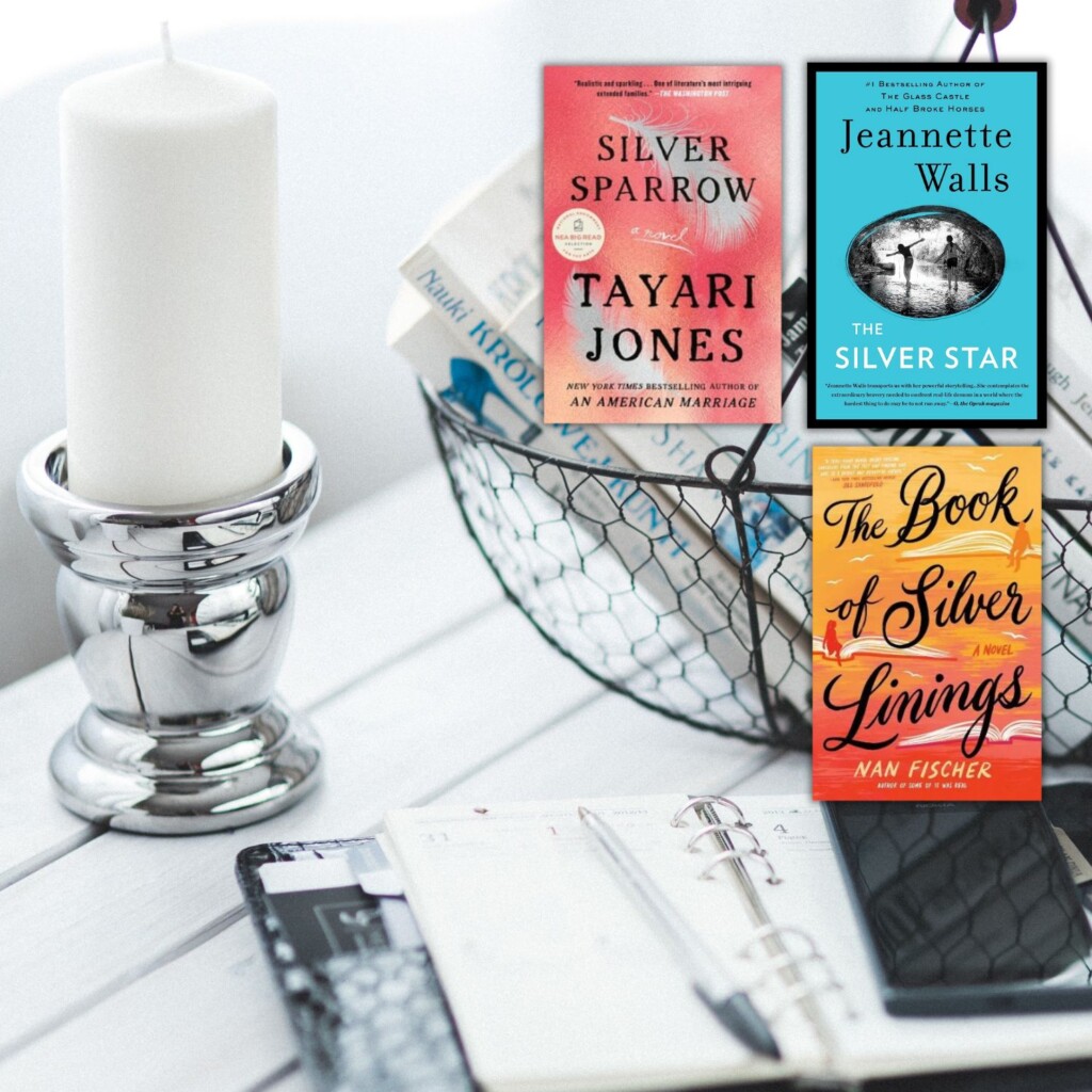 Silver candlestick on black and white table and 3 books