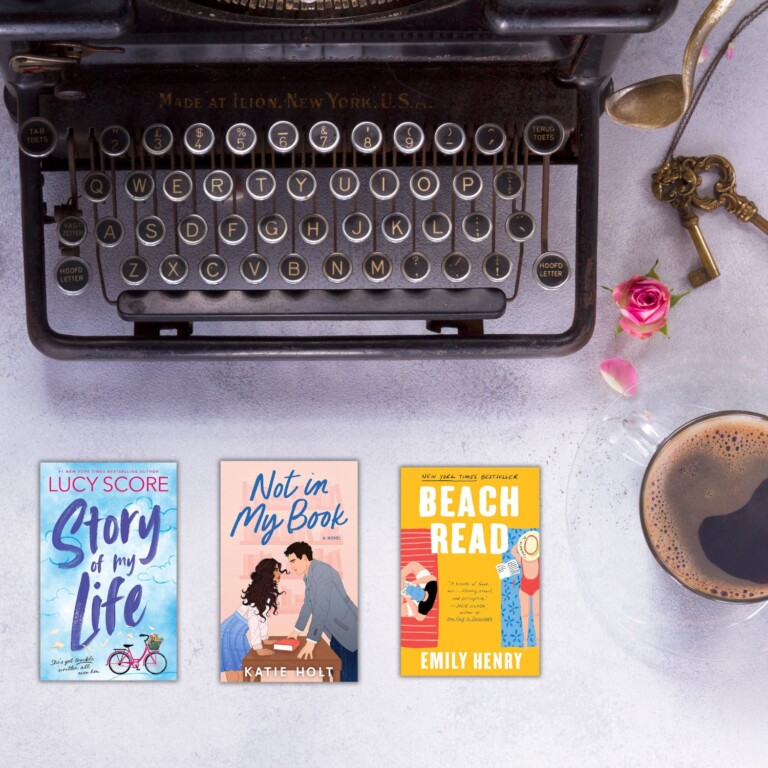 Vintage black typewriter on a light background with pink roses, a cup of coffee, and covers of three romance books about writers