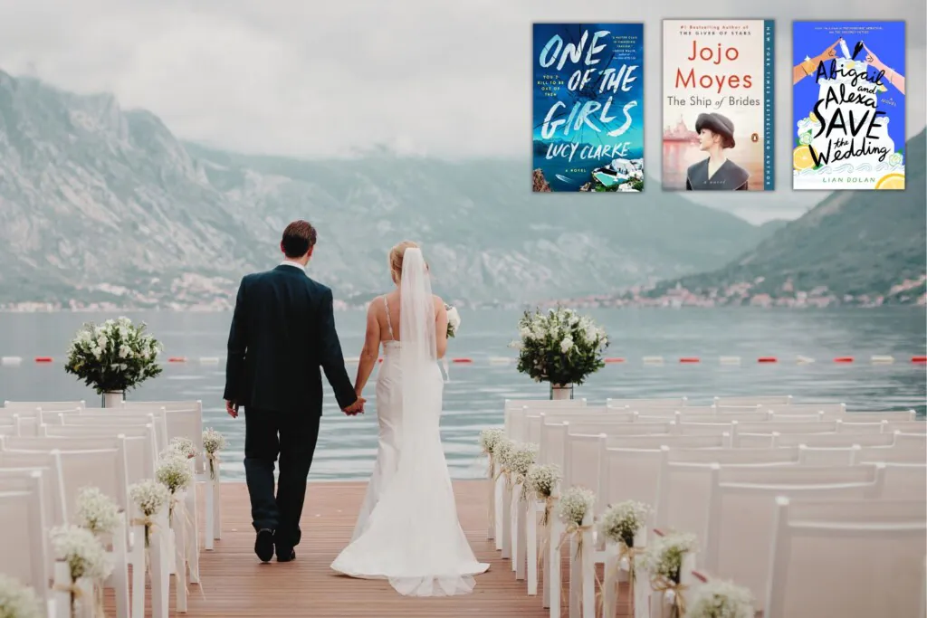 back view of bride and groom walking toward a lake and foggy mountains