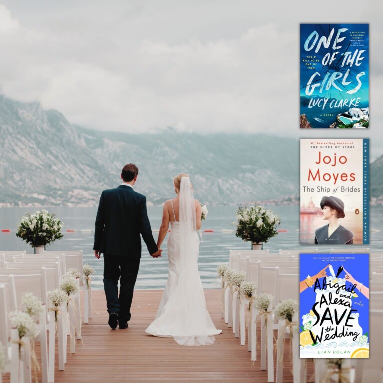 back view of bride and groom walking toward a lake and foggy mountains