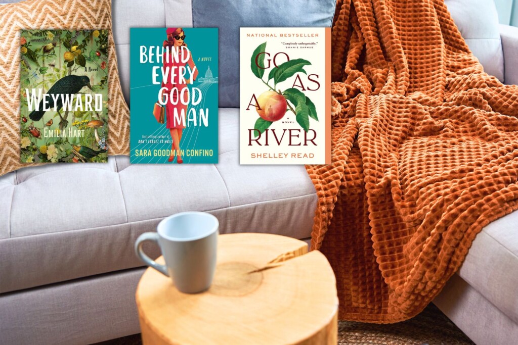 A couch with an orange pillow and blanket, a side table with a coffee mug, and three book covers with cozy fall reading vibes
