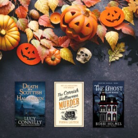 black chalkboard with orange halloween decorations and three halloween books