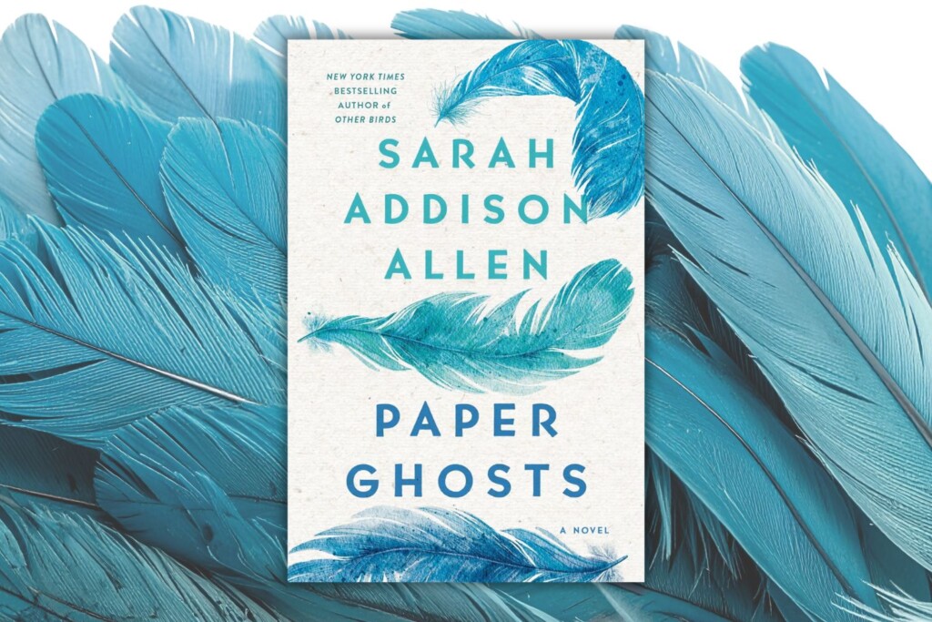 Paper Ghost book cover on top of teal feathers