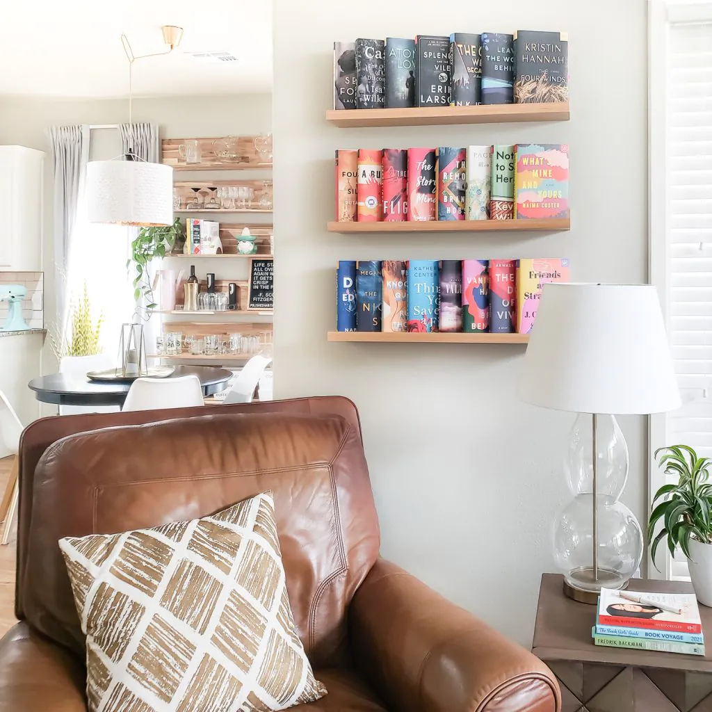 Books on wall behind leather chair