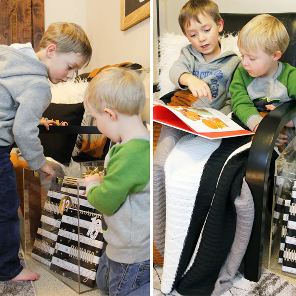 two little boys reading Christmas book together under a blanket