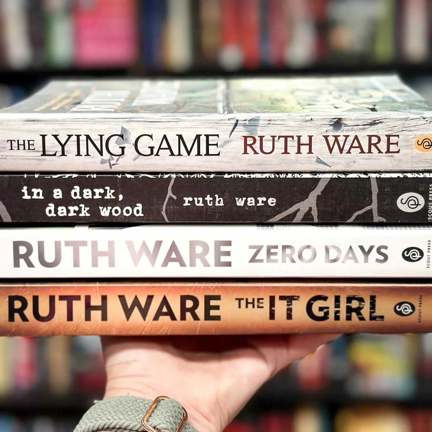 stack of 4 Ruth Ware books on a hand