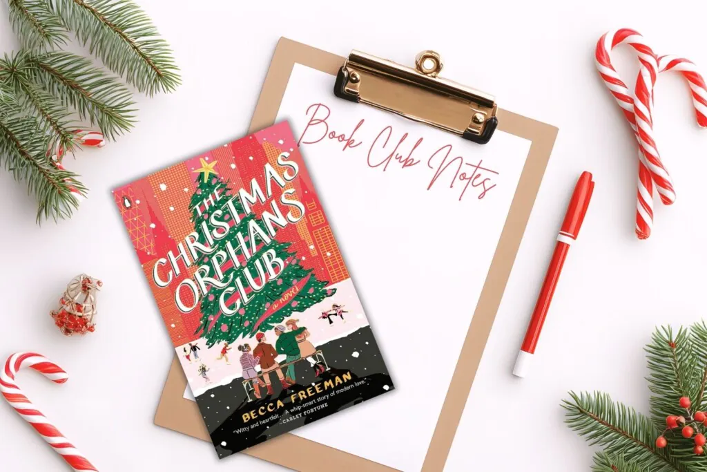 Flatlawy with a white background, pine branches in the corners, and candy canes. A cllipboard with and a red pen in the center with a paper that says Book Club Notes and a Christmas book sitting atop the clipboard